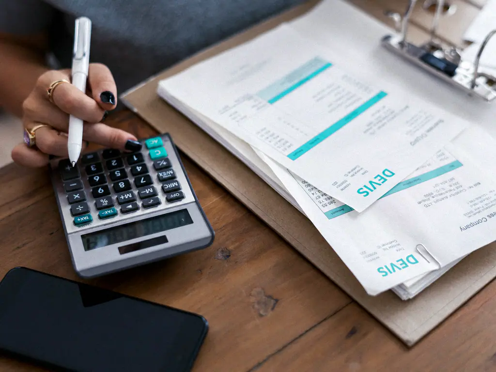 Devis papier et calculatrice sur un bureau, chiffrage en cours