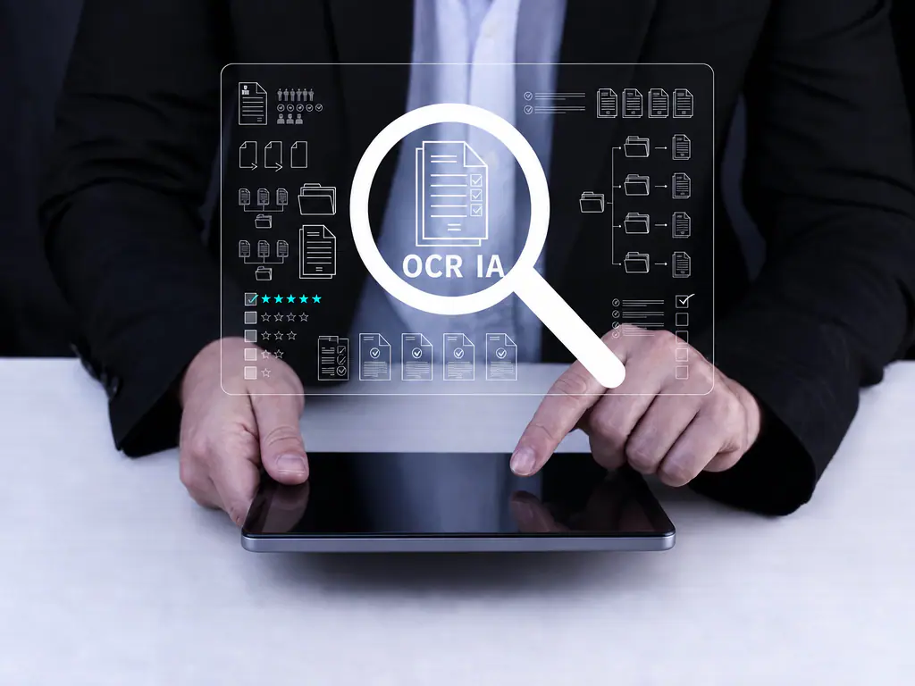 Écran de recherche documentaire « OCR IA » affiché au dessus d’une tablette