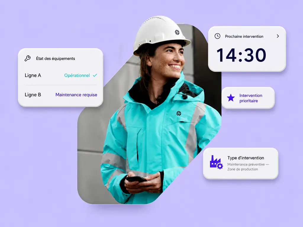 Une technicienne de maintenance en tenue de travail consulte son tÃ©lÃ©phone
