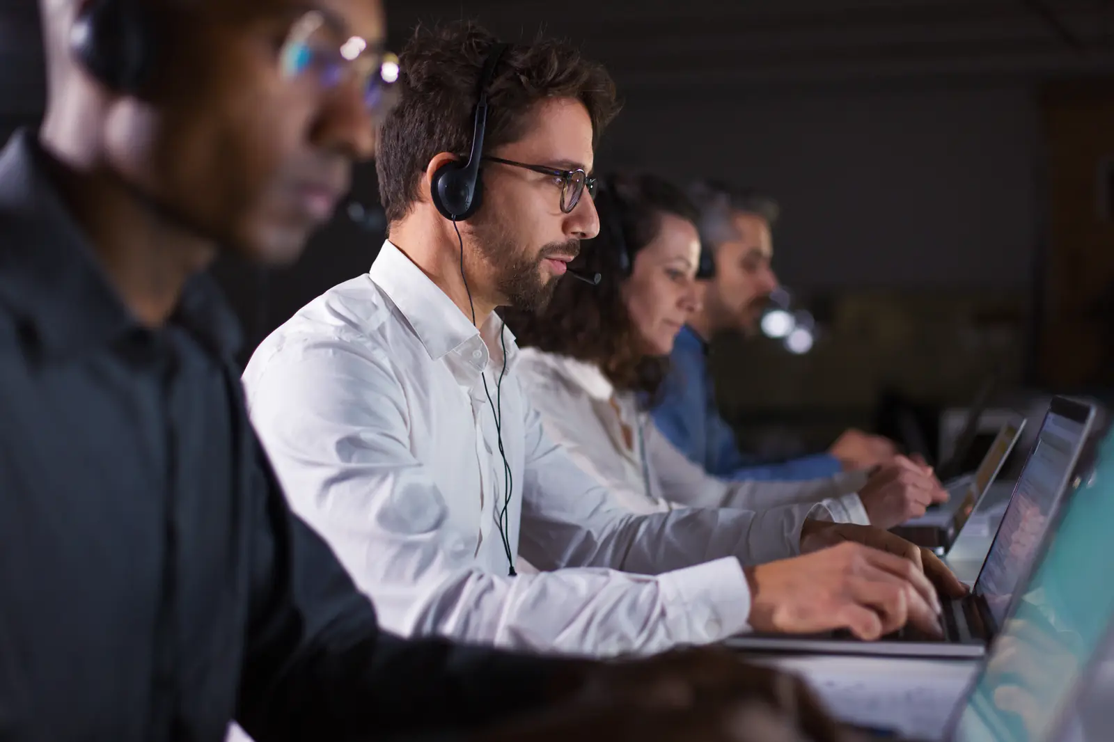 Un conseiller en centre de contact répond à un client avec un casque audio